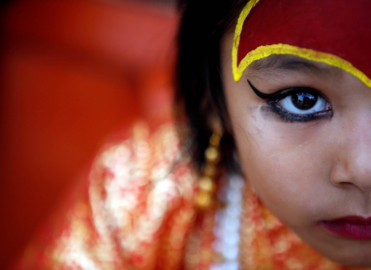 A young girl dressed as the Living Goddess Kumari takes part in the Kumari Puja festival in Kathmandu